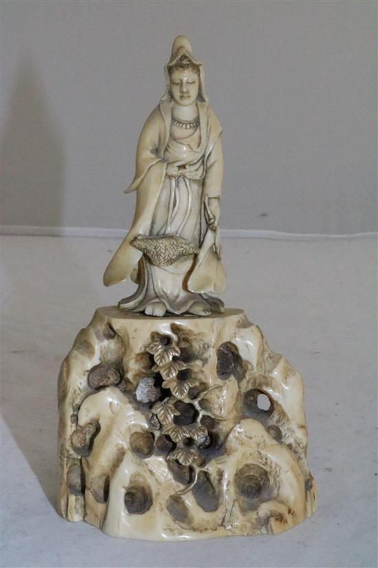 A Japanese ivory figure of Kwannon standing on rockwork, early 20th century, 14.5cm